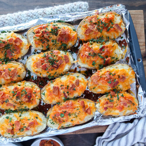 Twice baked potatoes on a foil lined baking sheet.