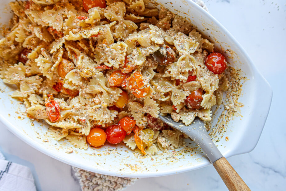 Baked feta pasta in an oval, white baking dish.