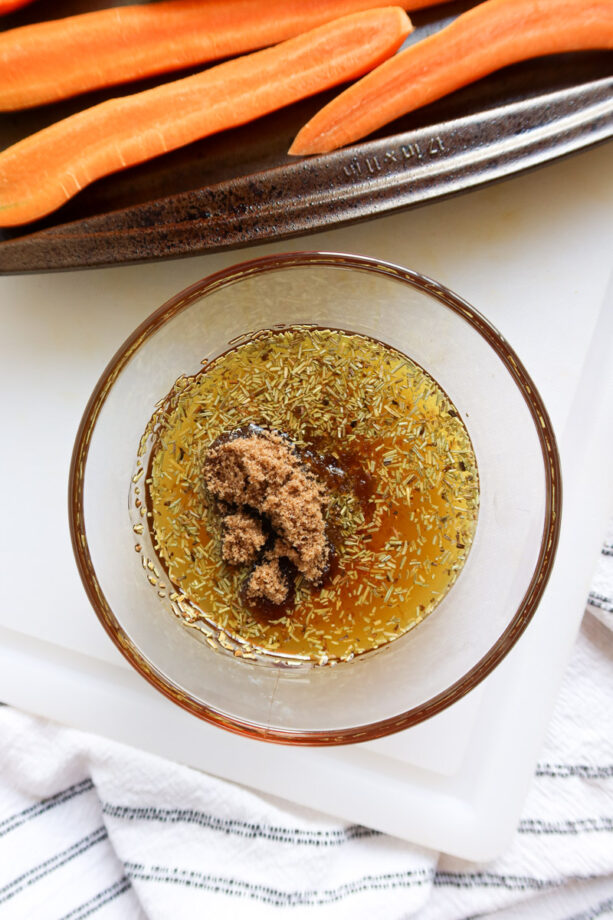 Close up of sweet honey and brown sugar glaze ingredients in a small glass bowl. 