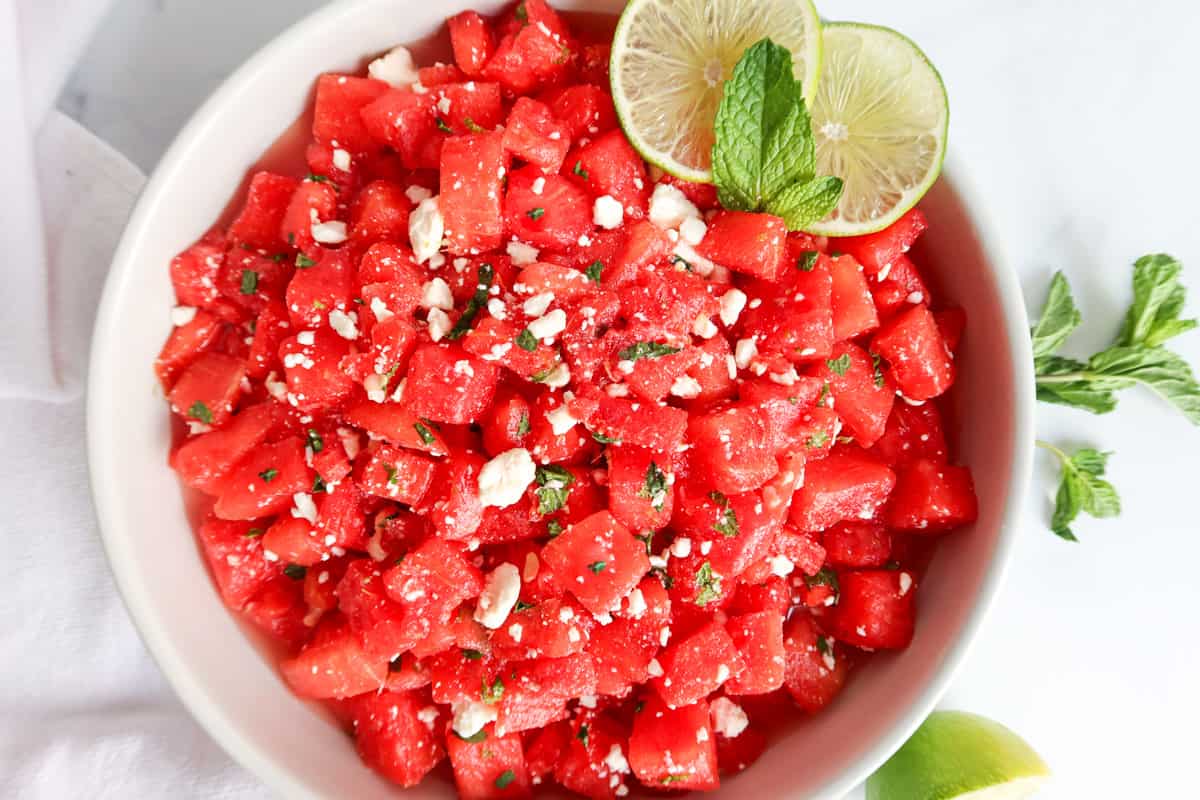 Watermelon salad in a white bowl.