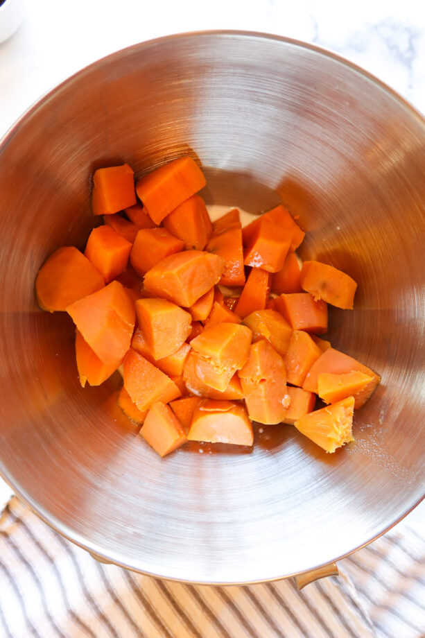 Steamed sweet potato cubes in a mixing bowl. 