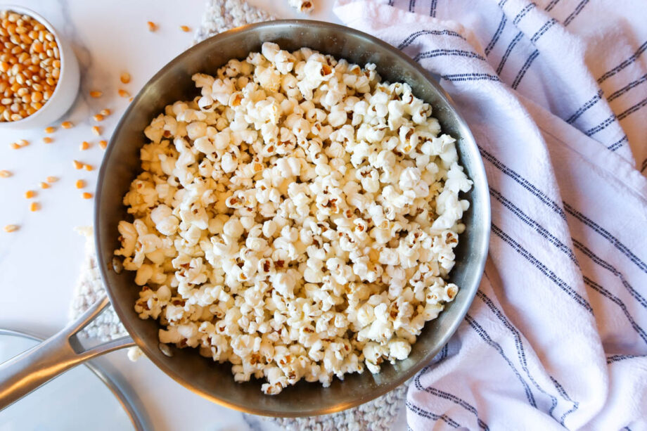 Homemade, stovetop popcorn in a large, stainless steel pan.