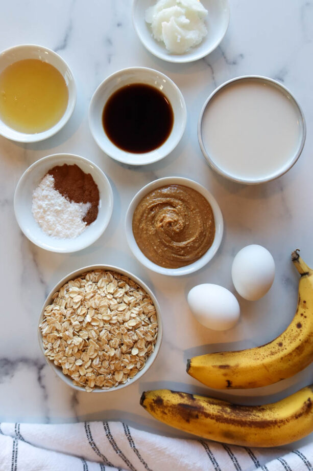 Ingredients for peanut butter baked oatmeal arranged on a white countertop.