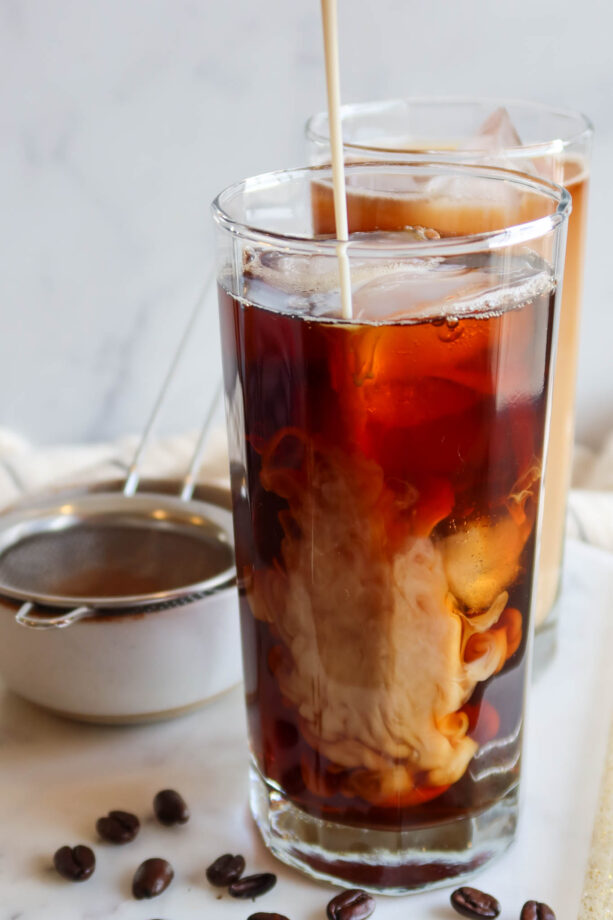 Adding protein shake to iced cold brew.