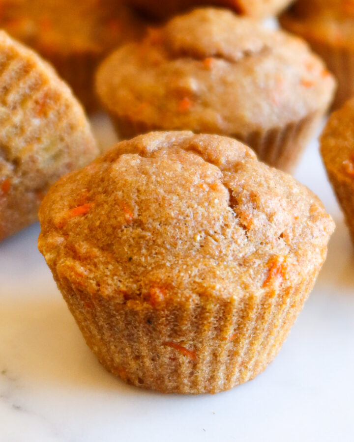 Banana carrot muffins on a white countertop.
