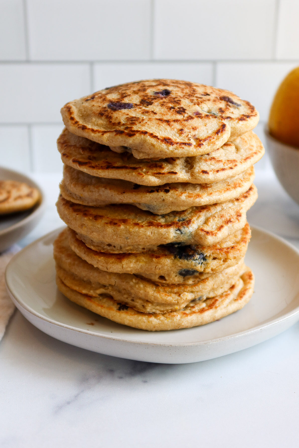 A stack of blueberry oatmeal pancakes.