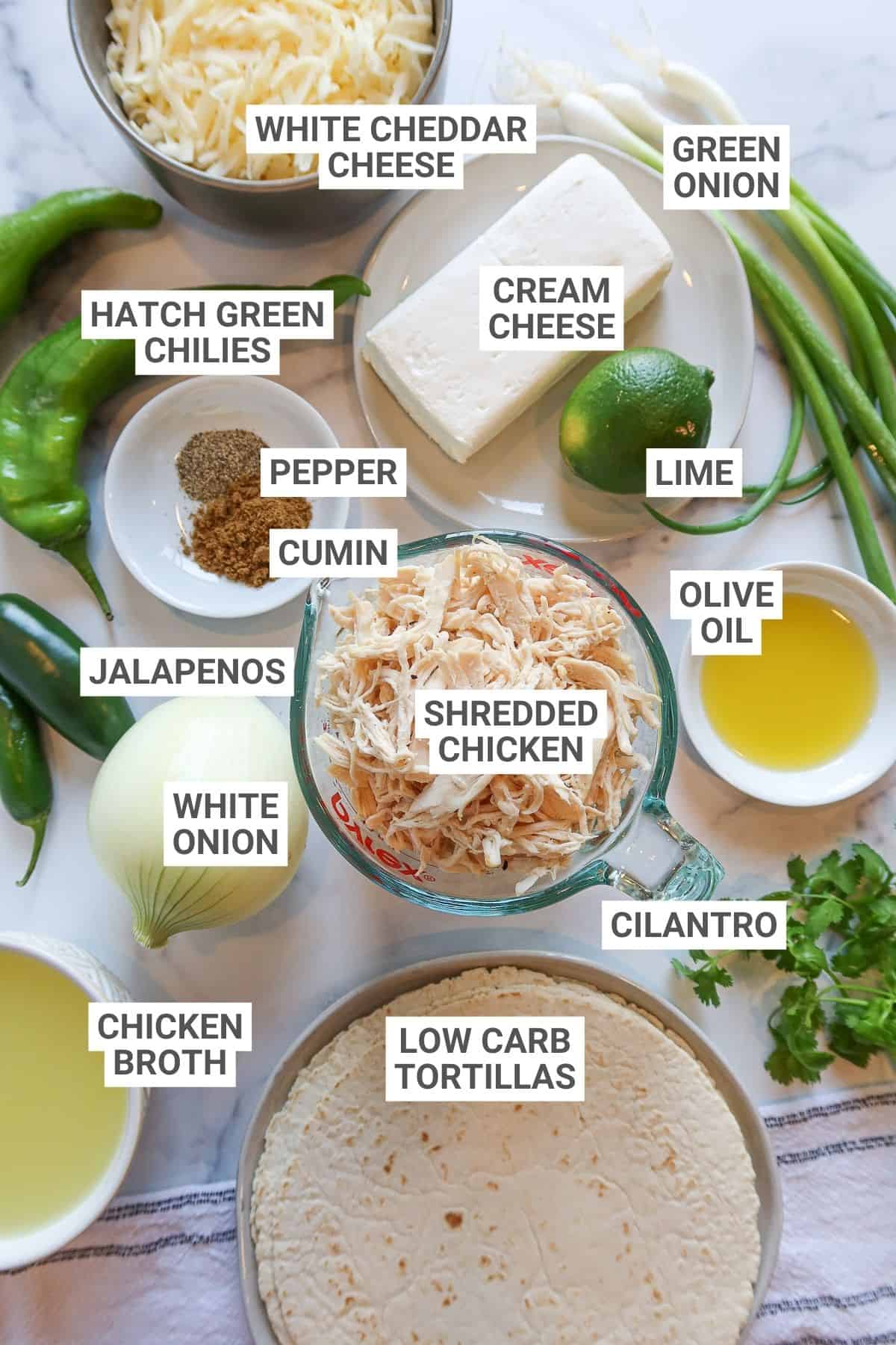 White chicken enchilada ingredients arranged on countertop with text overlay labels.