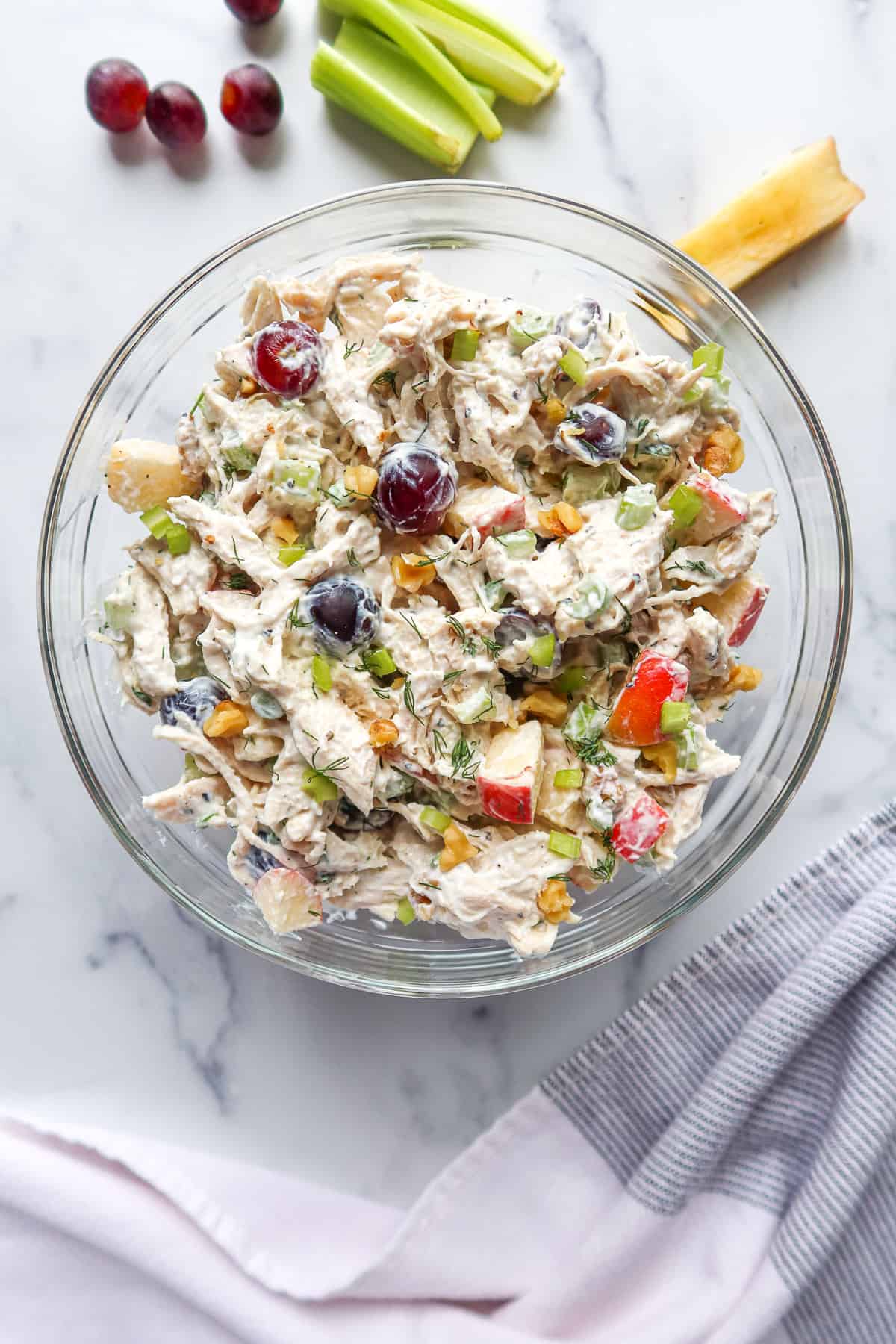 Greek yogurt chicken salad in a glass mixing bowl.