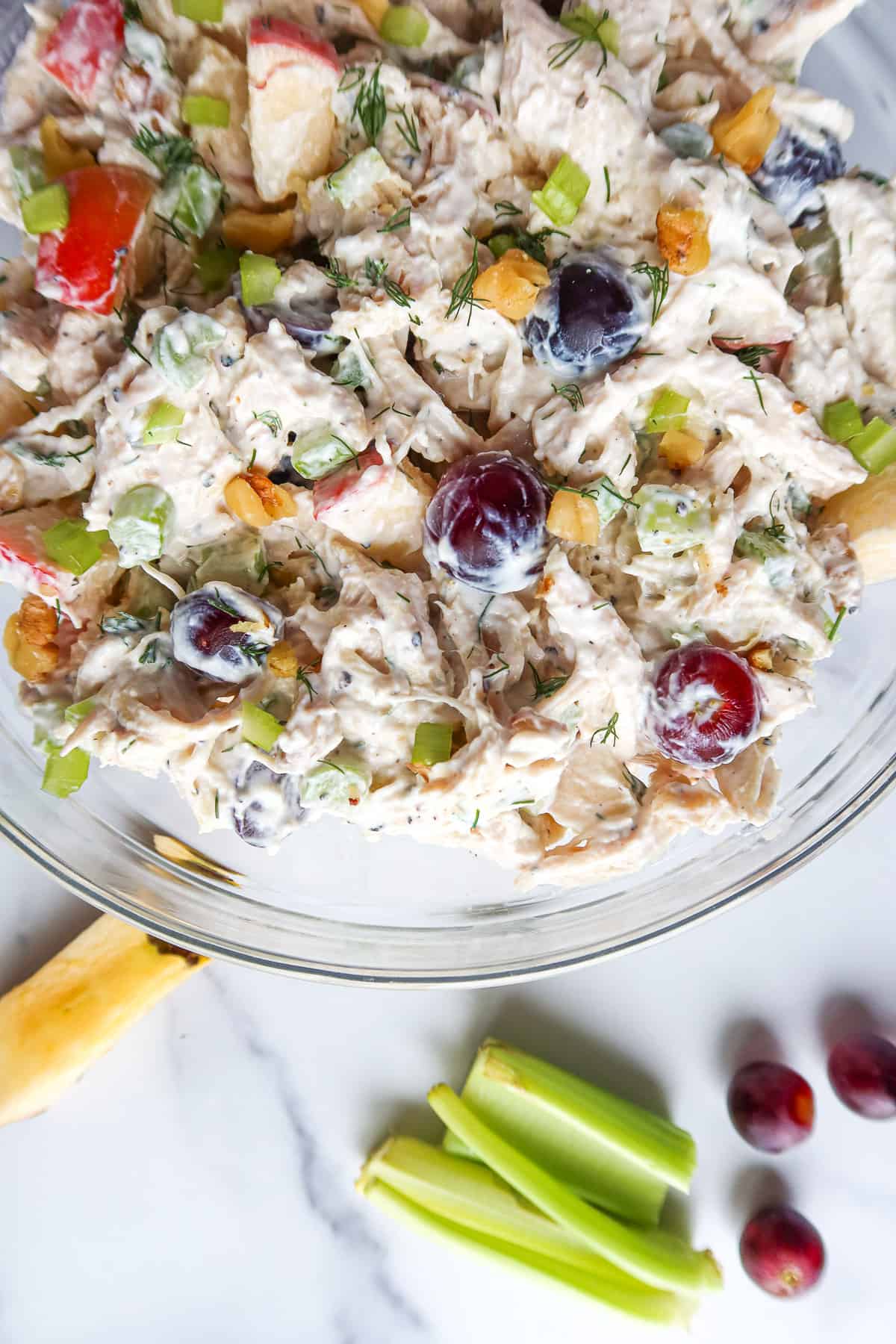 Greek yogurt chicken salad in a glass mixing bowl.