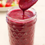 Blueberry vinaigrette salad dressing in a small, glass jar.