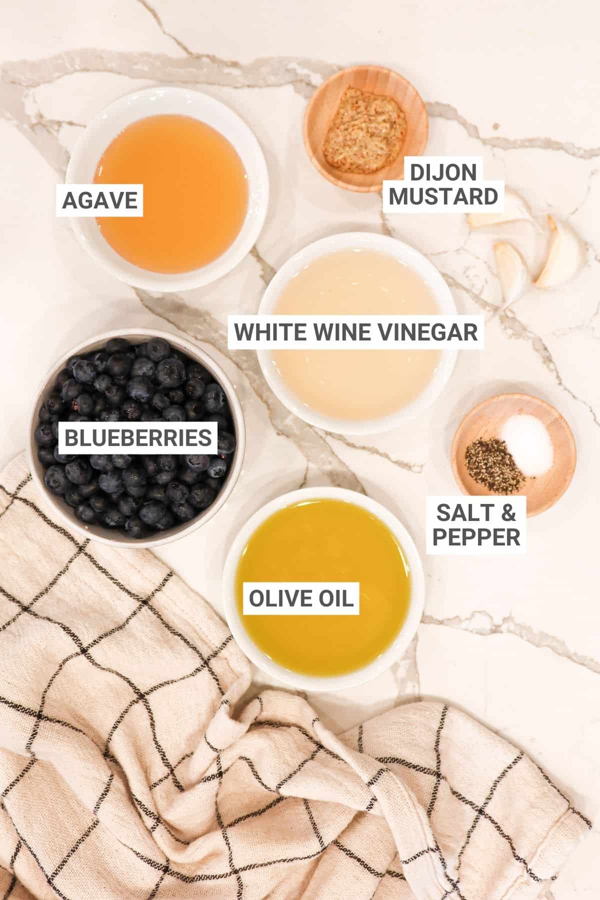 Blueberry vinaigrette dressing ingredients on a white countertop with text overlay for Pinterest.