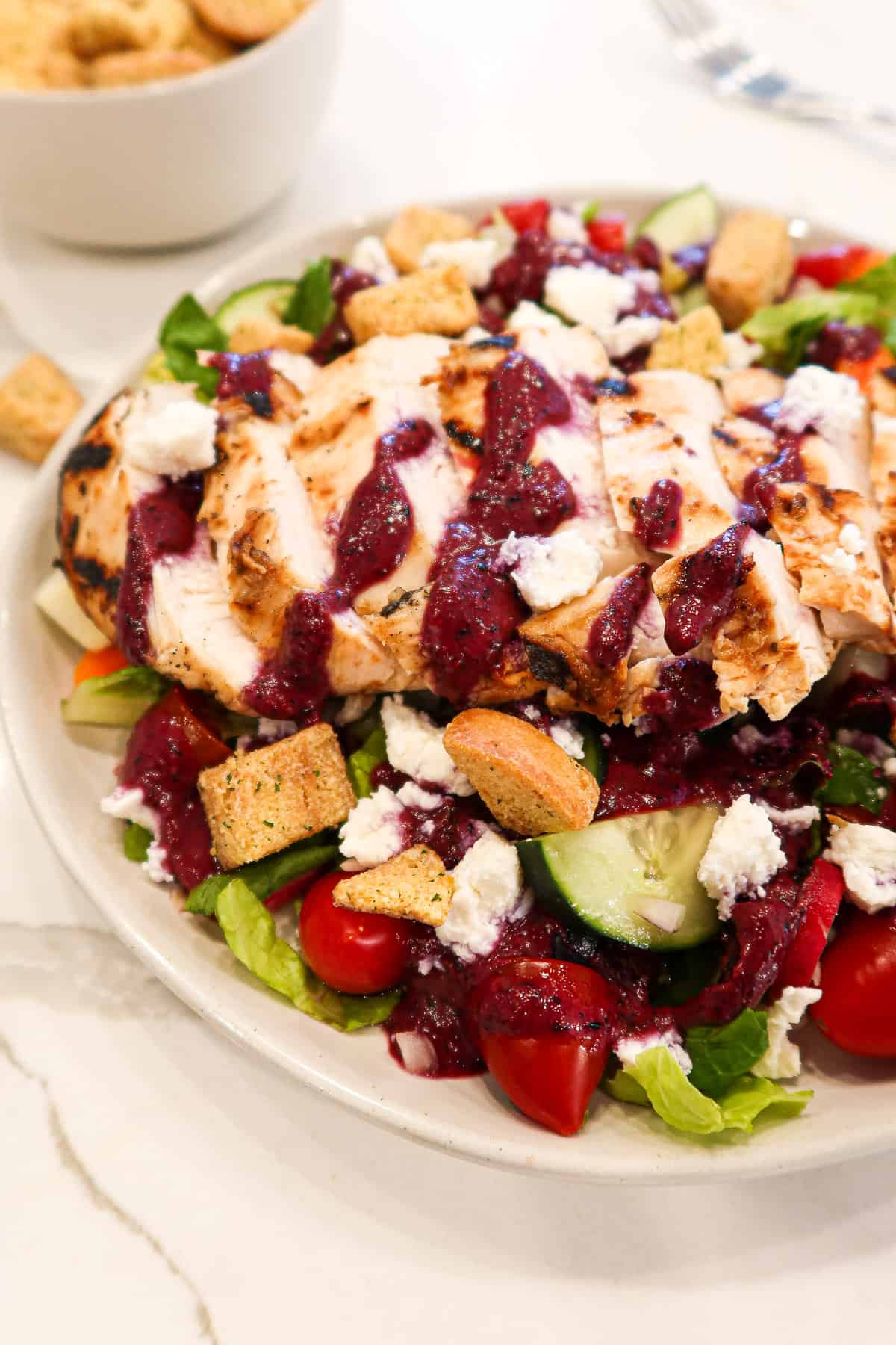 Blueberry dressing on a garden salad with grilled chicken.