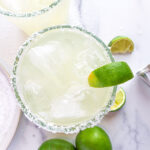 Skinny margaritas with lime wedges.