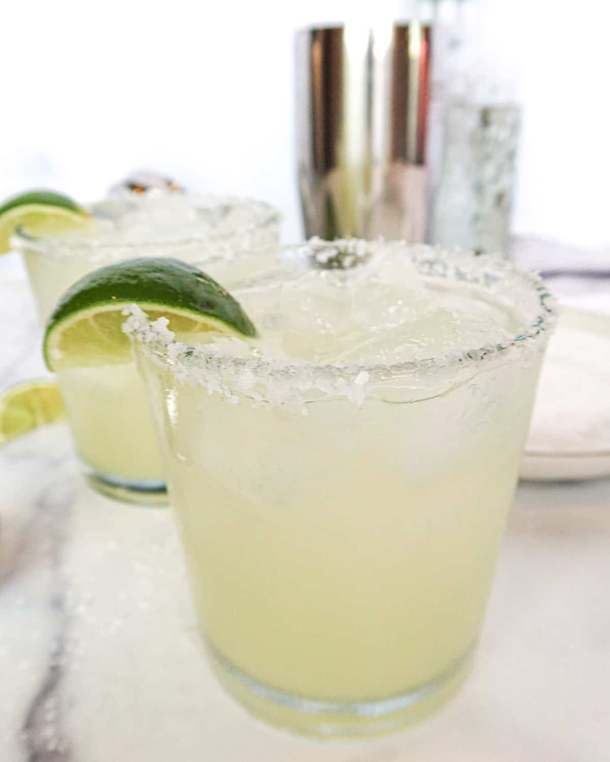 Skinny margaritas with lime wedges.