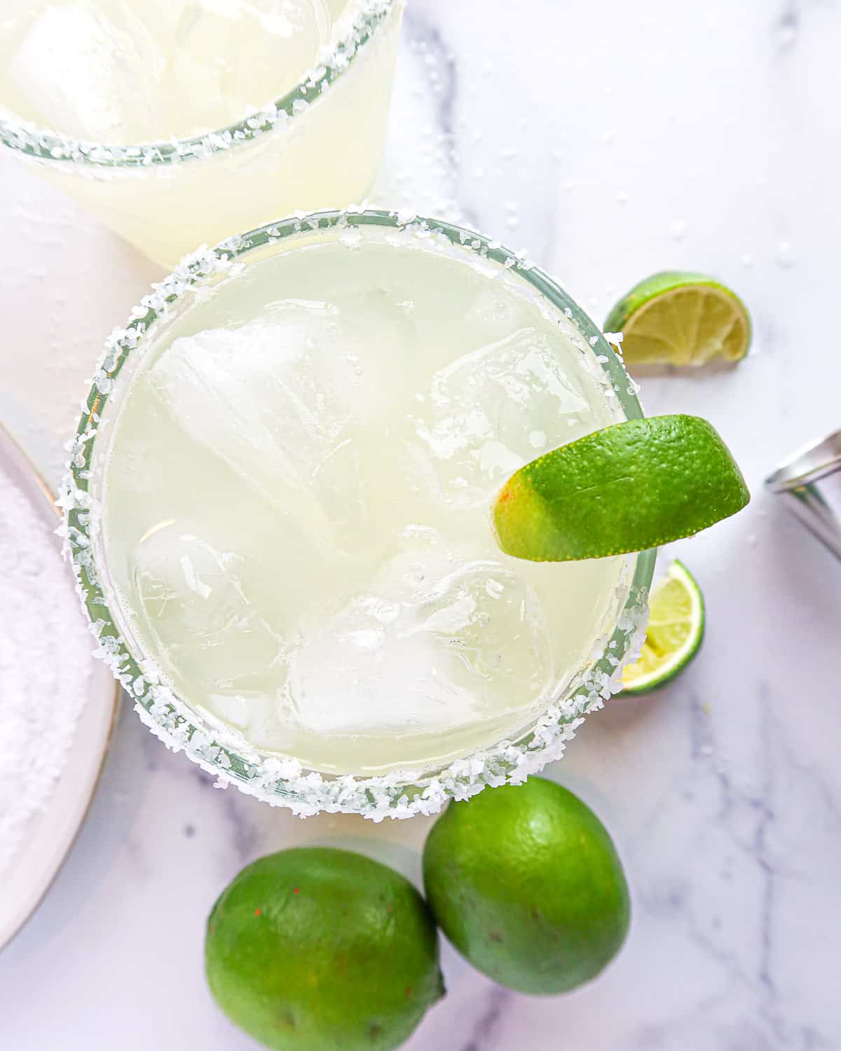 Skinny margaritas with lime wedges.