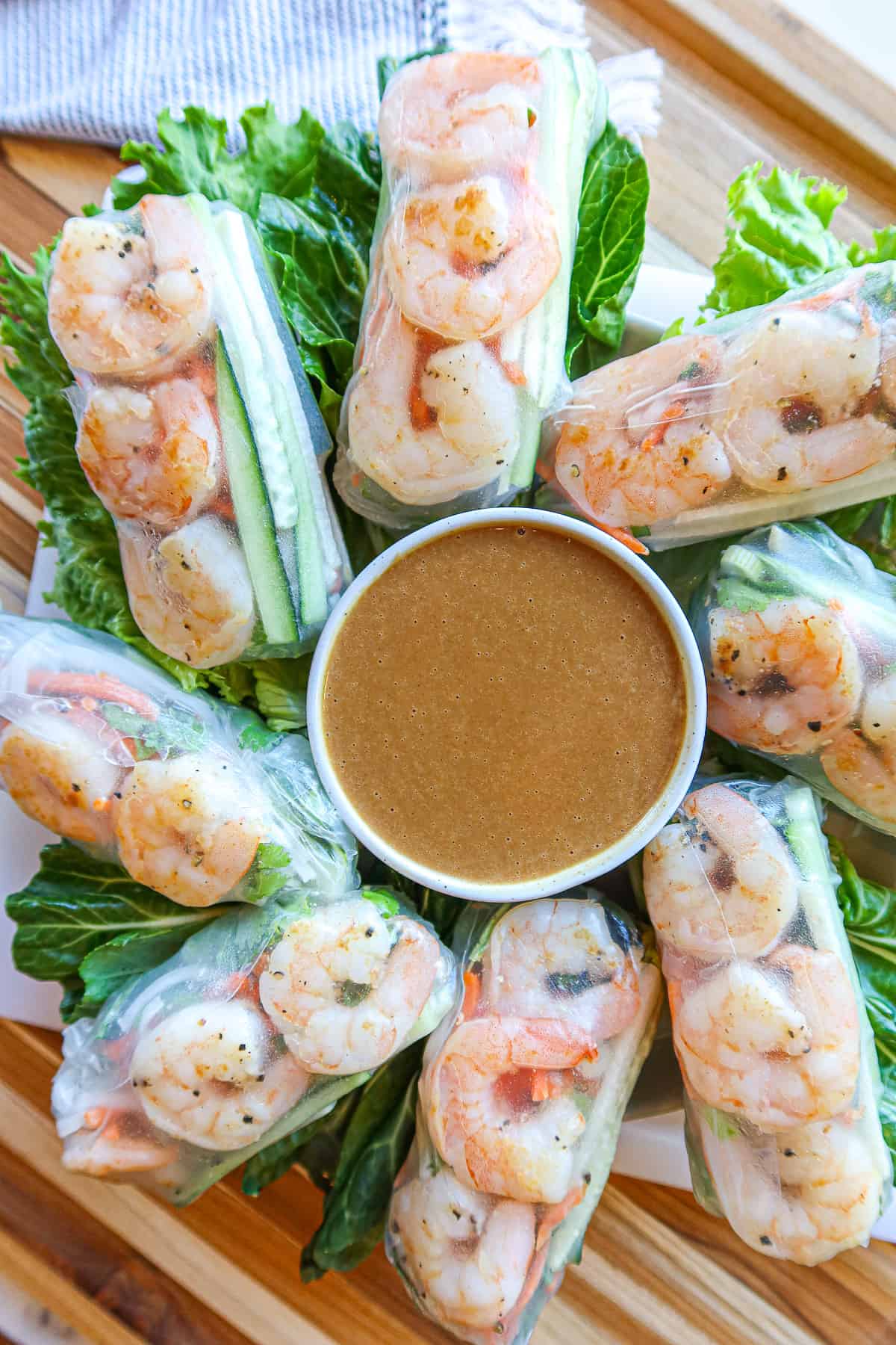 Spring rolls and a bowl of peanut dipping sauce.