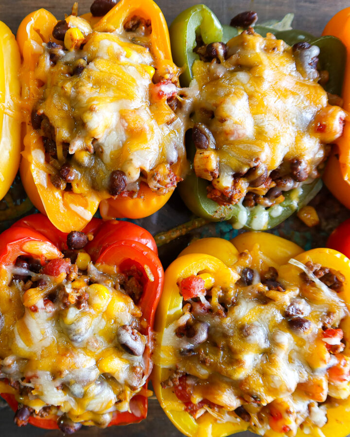 Baked stuffed peppers in a glass baking dish.