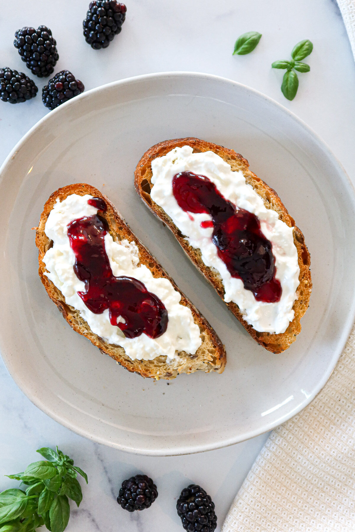 Toasted bread topped with creamy burrata cheese and blackberry preserves.