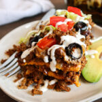 A plated piece of low carb taco casserole with toppings.