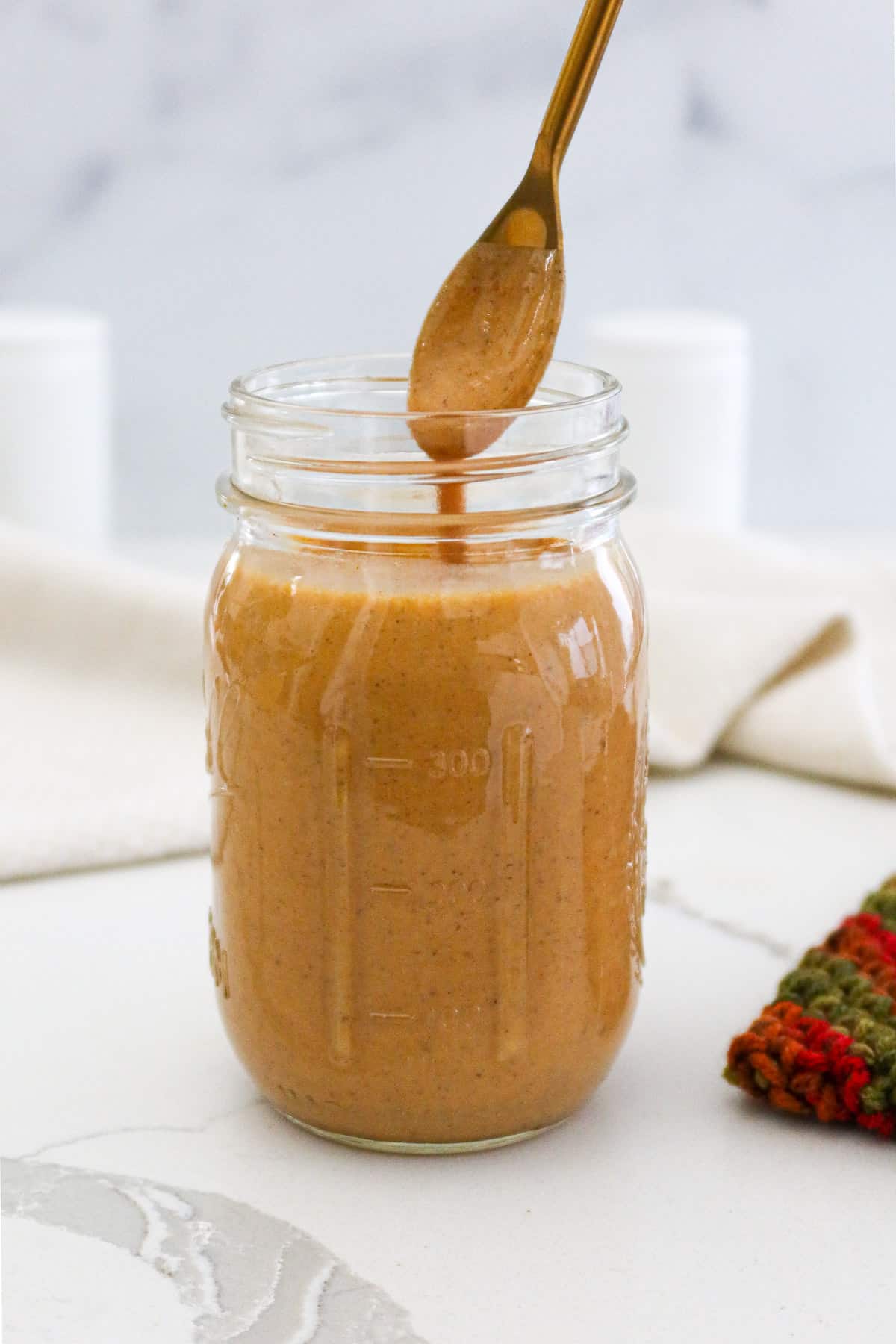 Pumpkin spice sauce in a glass jar.