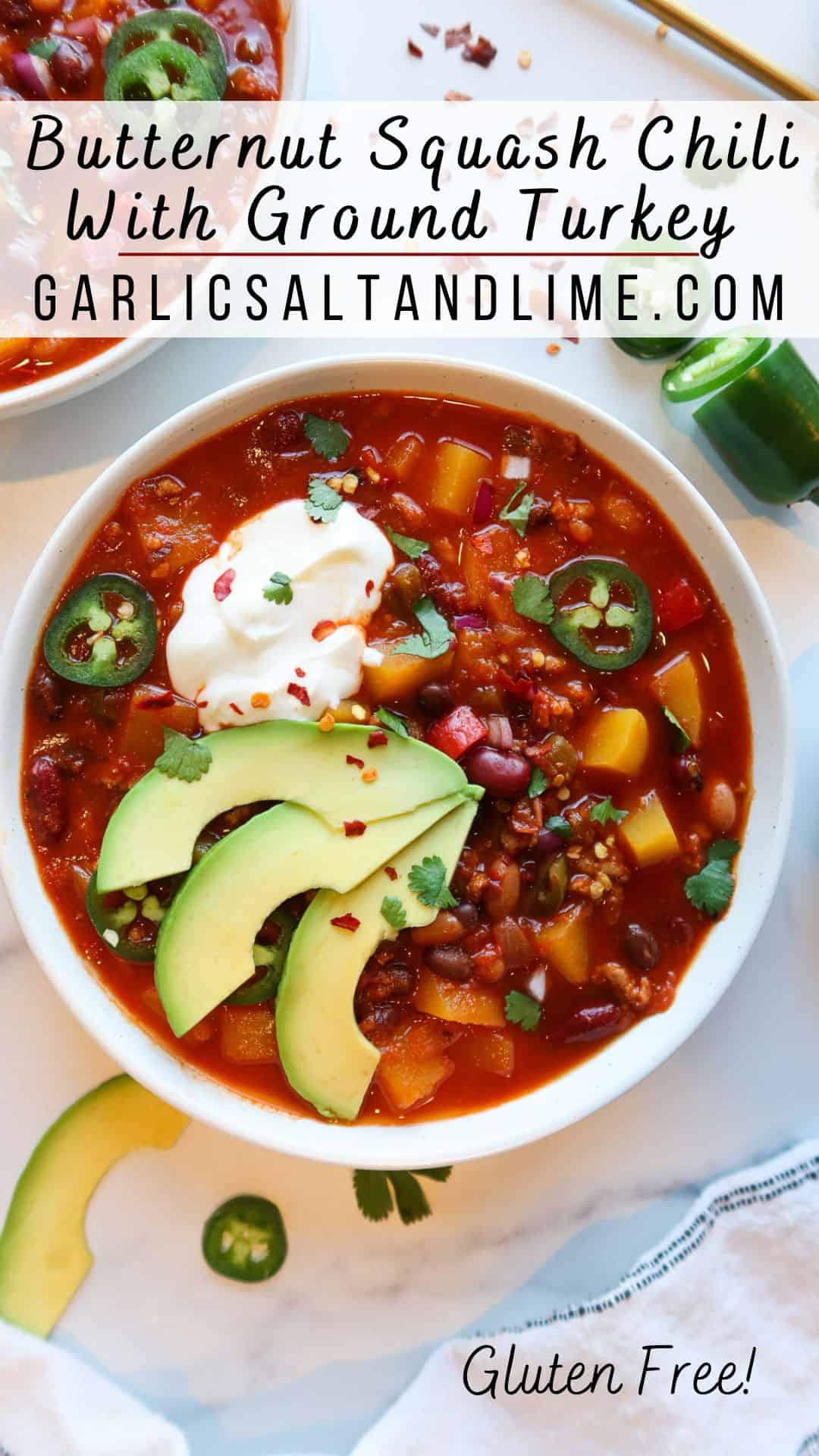 Chili in a white serving bowl with toppings and text overlay for Pinterest.