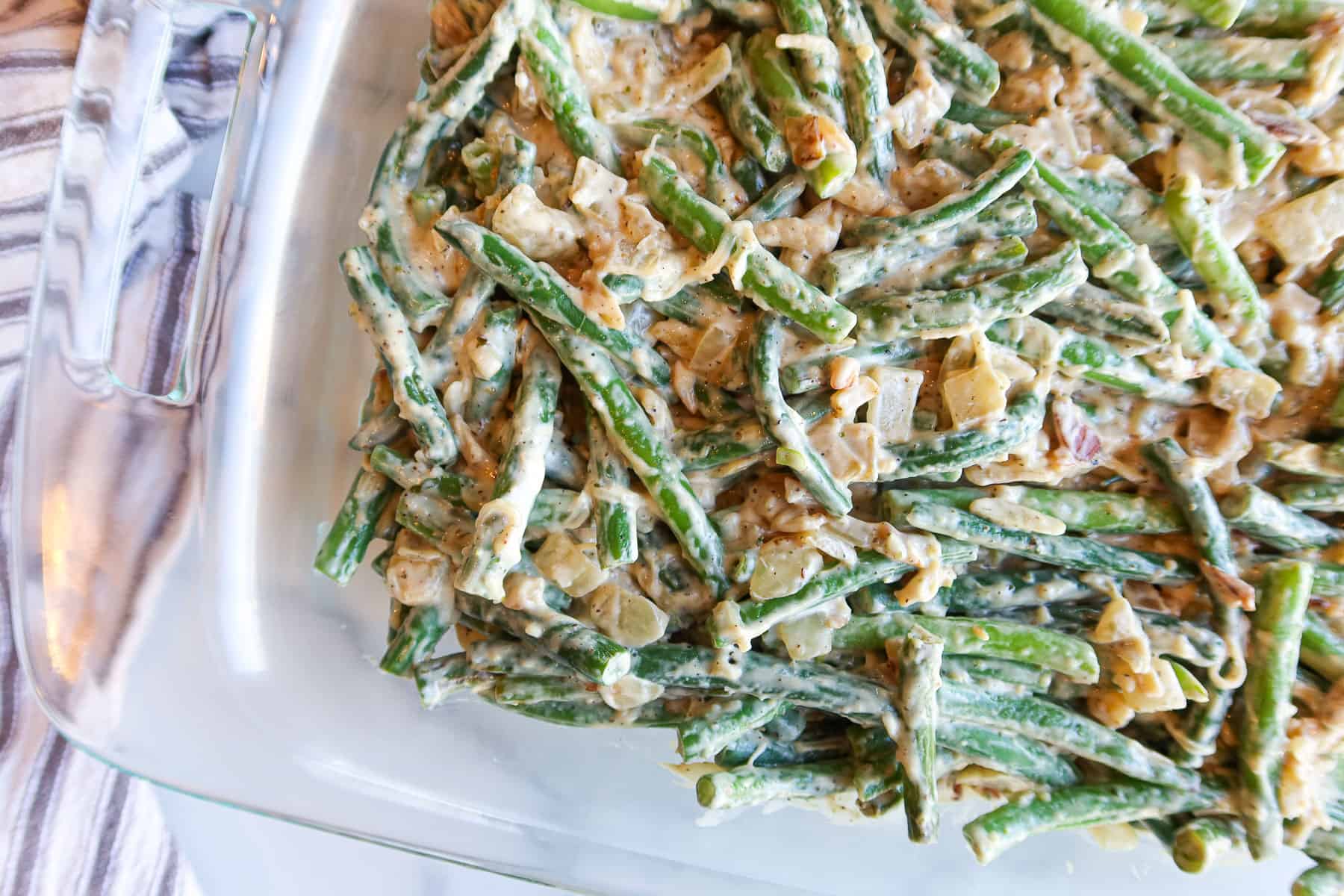 Green beans, sauce and cheese mixed together in baking dish.
