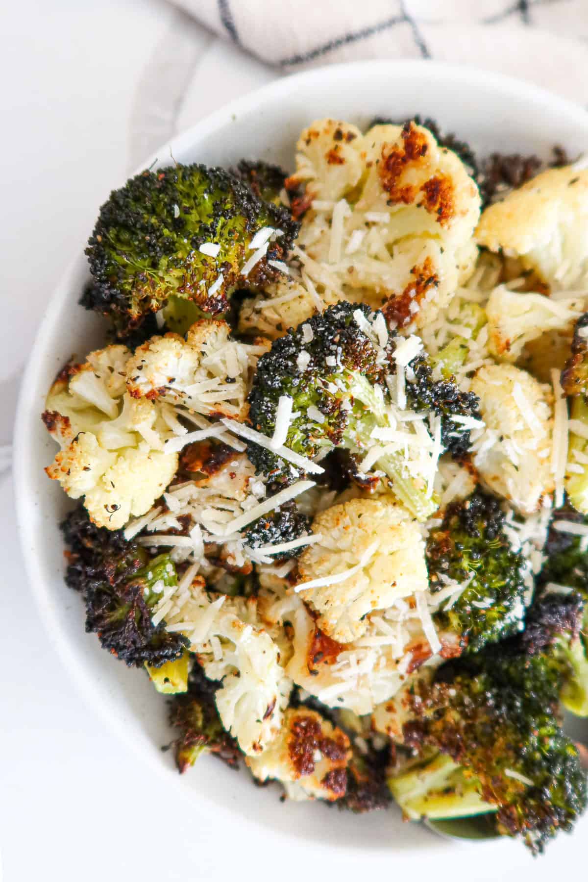 Roasted cauliflower and broccoli sprinkled with parmesan cheese.