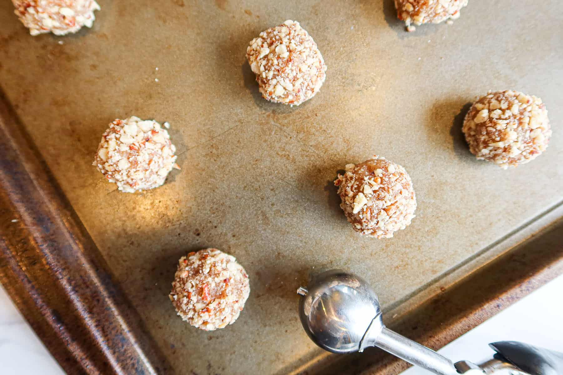 Cookie dough balls rolled in crushed nuts.