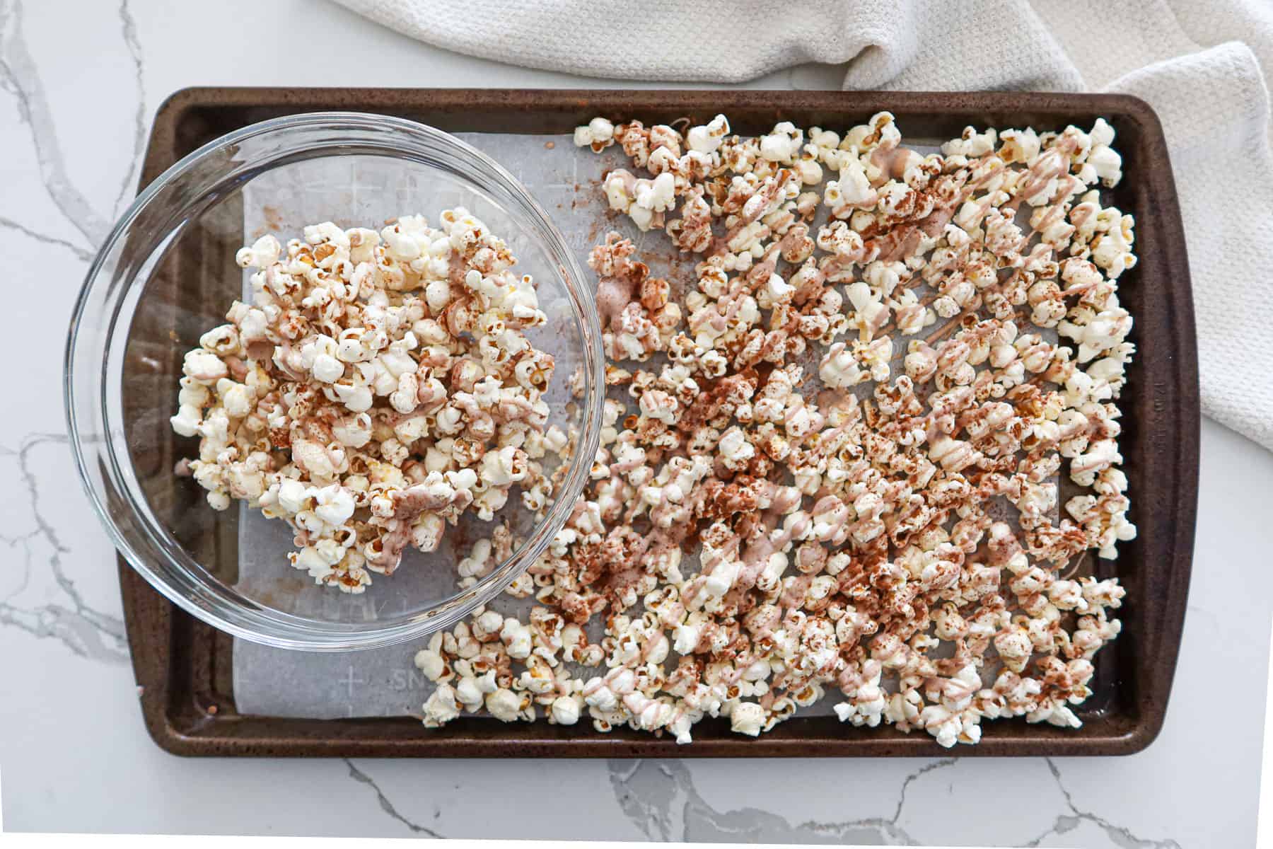 Breaking cinnamon popcorn into pieces and putting them in a bowl.