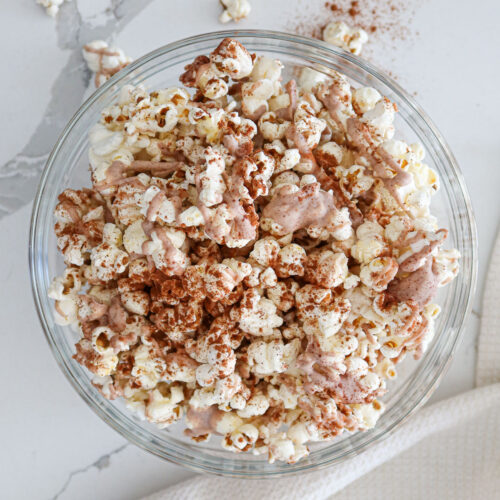 Cinnamon popcorn in large glass bowl.