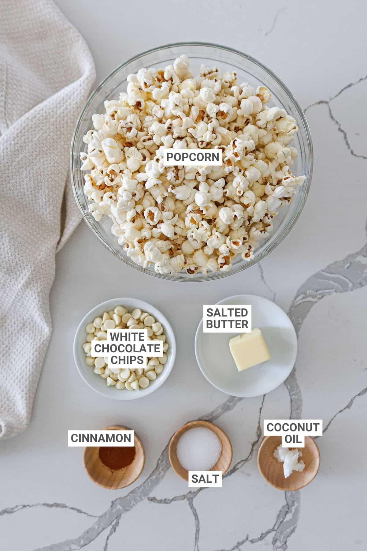 Ingredients for cinnamon popcorn with text overlay labels.