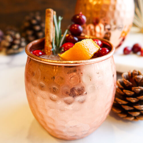 Cranberry Moscow mule in a copper mug.