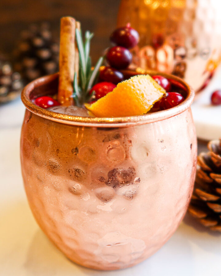 Cranberry Moscow mule in a copper mug.