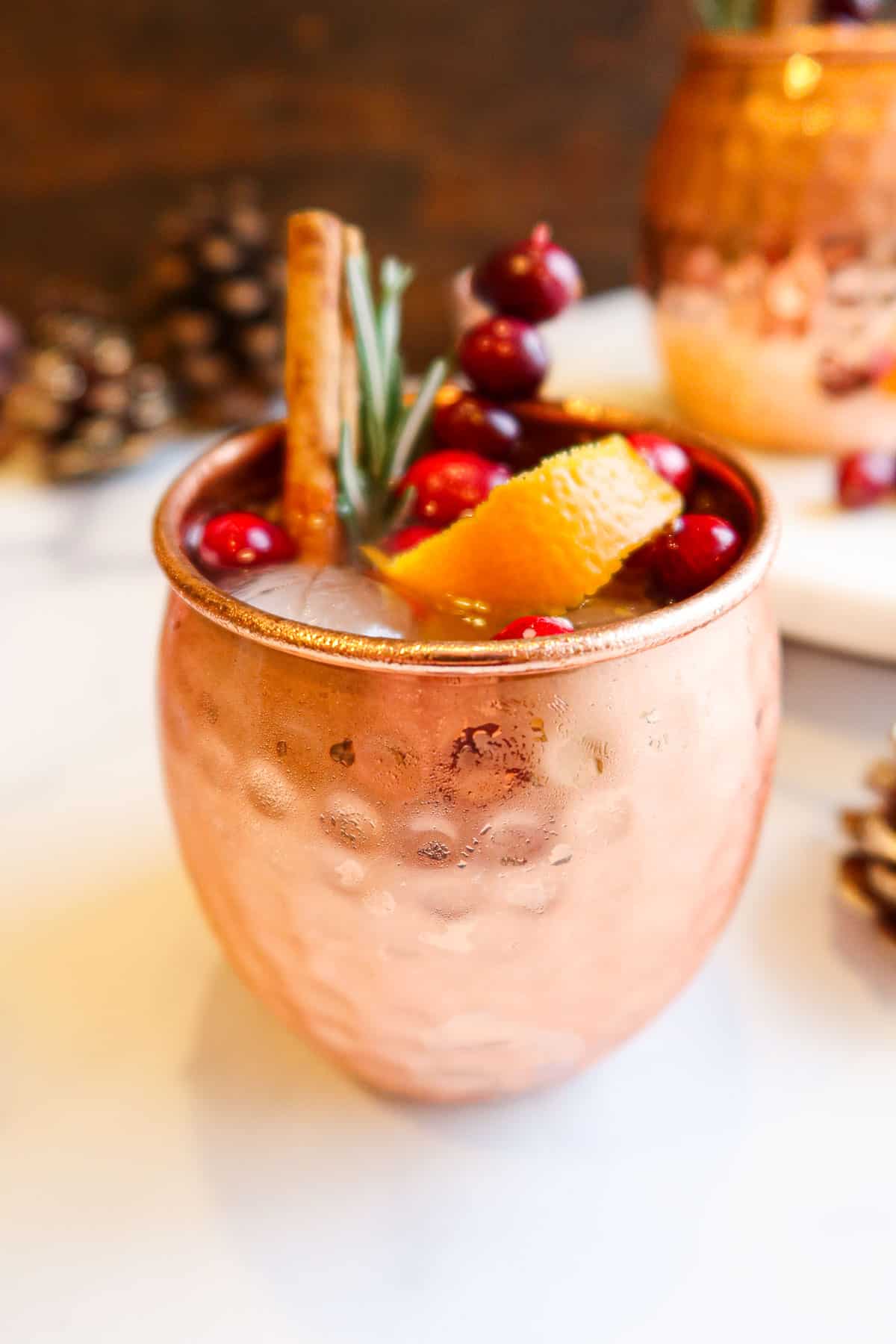 Cranberry Moscow mule in a copper mug.