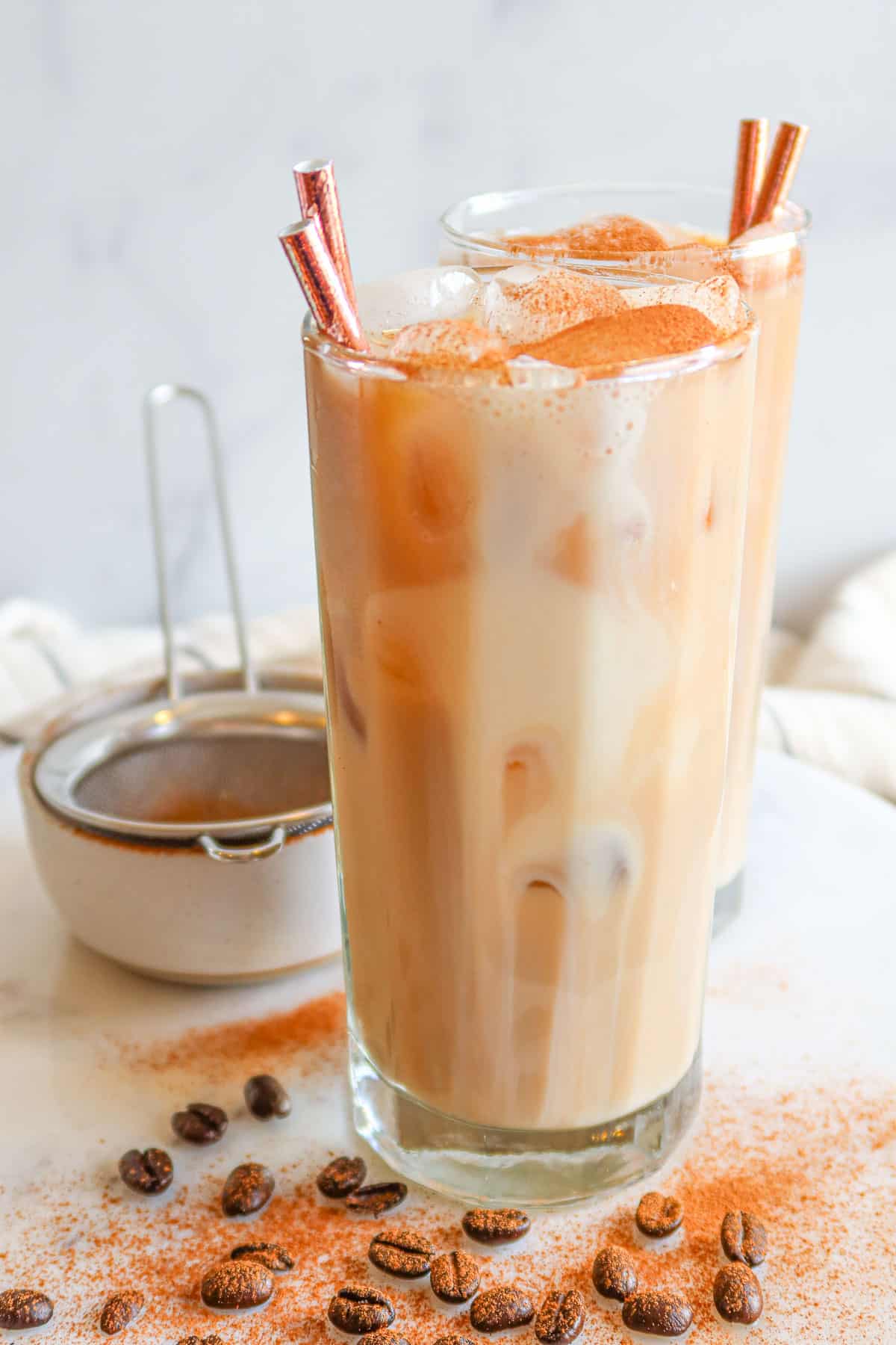 Protein coffee in clear drinking glasses with straws.