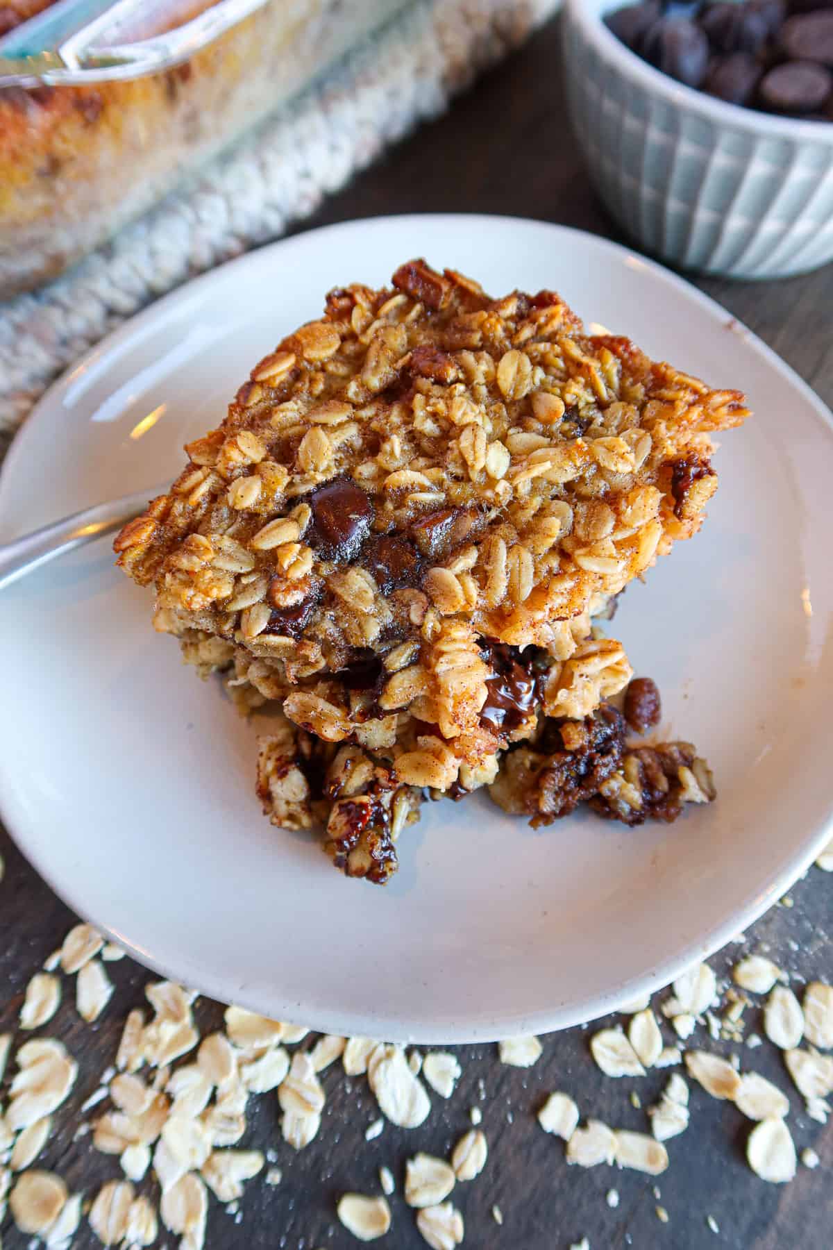 A piece of chocolate chip baked oatmeal on a small, white plate.