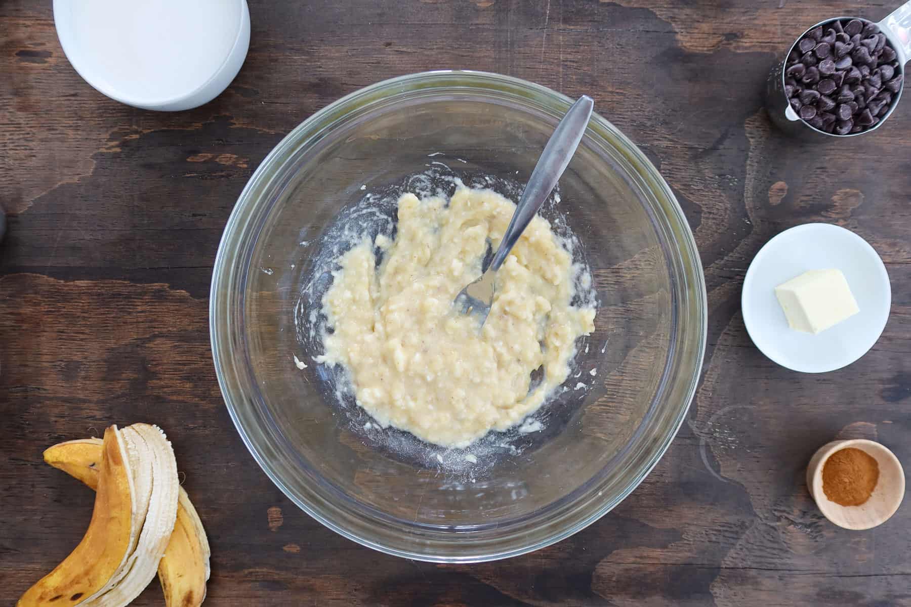 Mashed bananas in a large glass bowl.