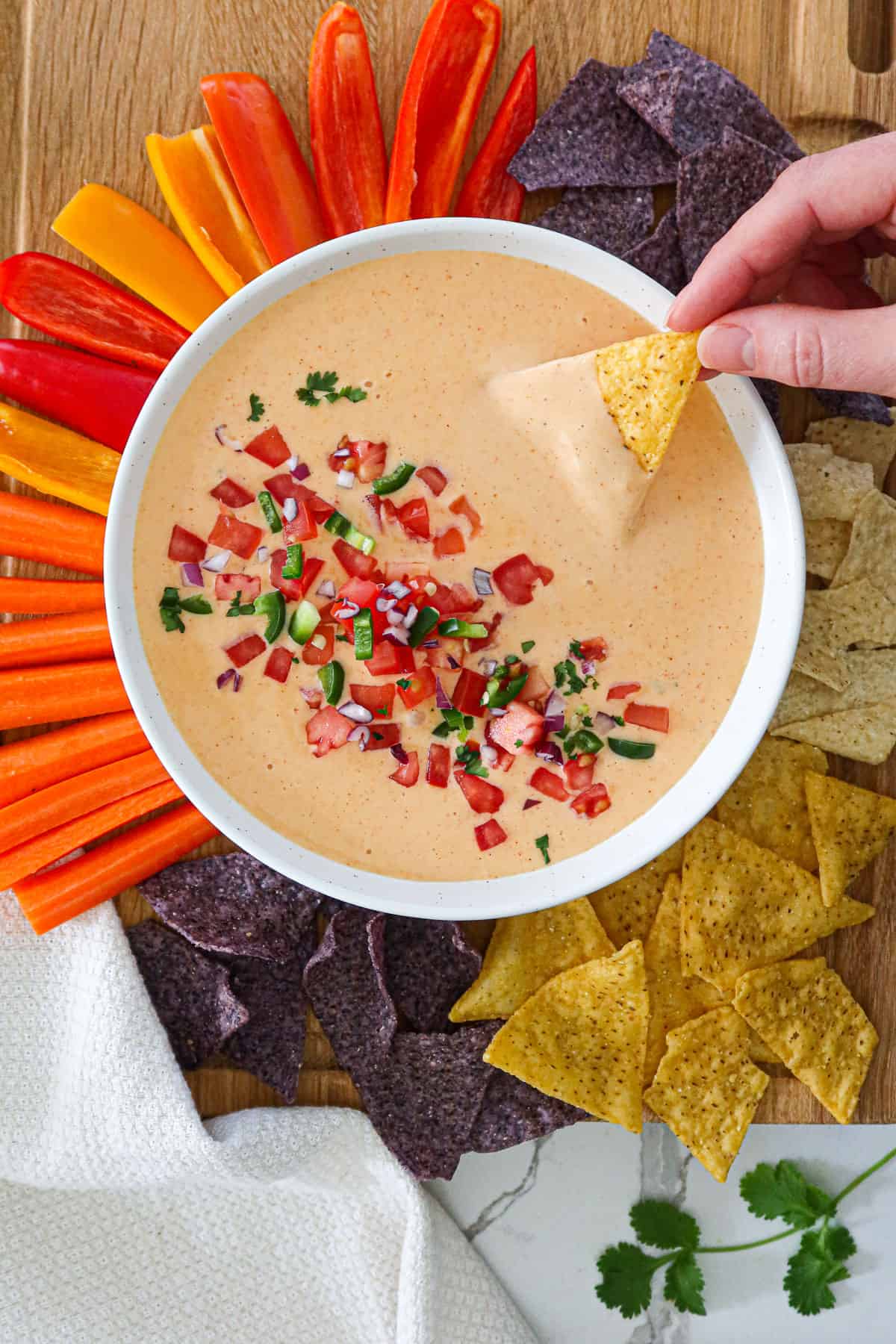 Dipping a tortilla chip in healthy queso dip.