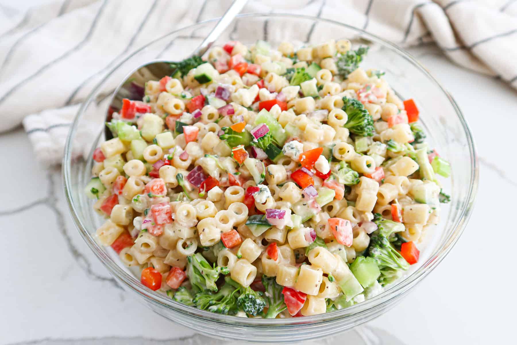 Ditalini pasta salad in a large glass bowl.