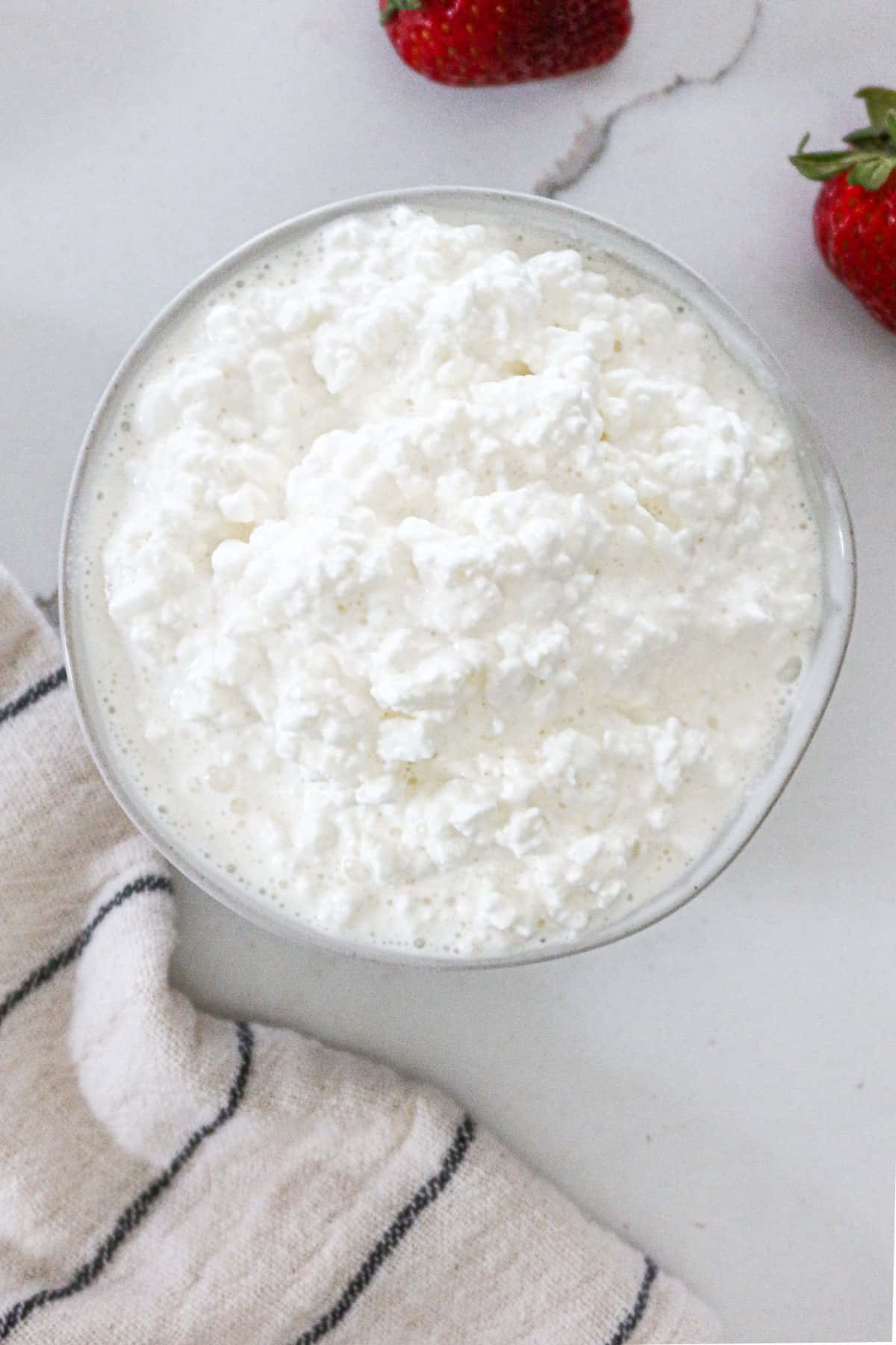 A bowl full of cottage cheese.