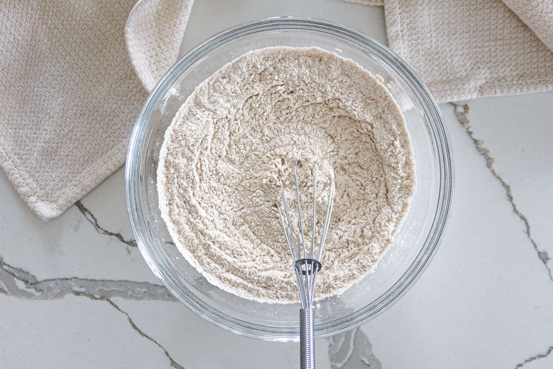 Dry ingredients whisked together in a mixing bowl.