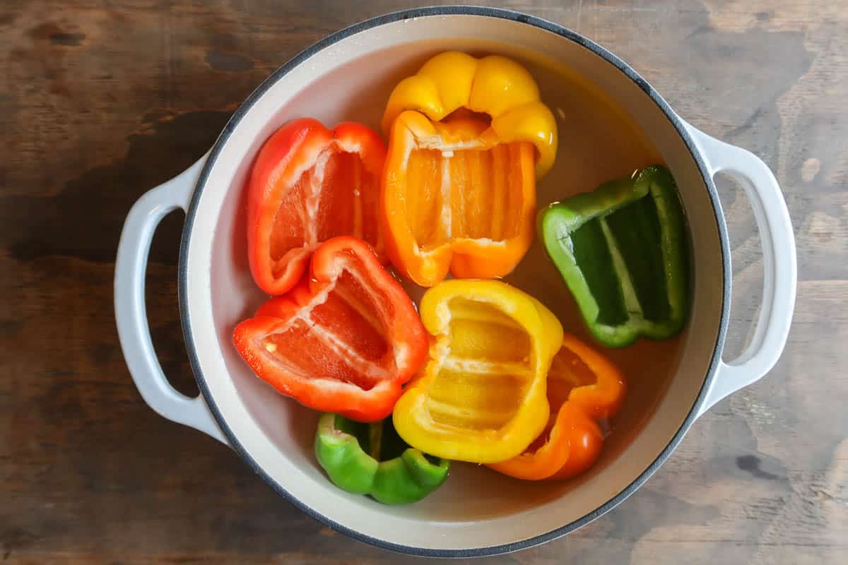 Blanching bell peppers in hot water.