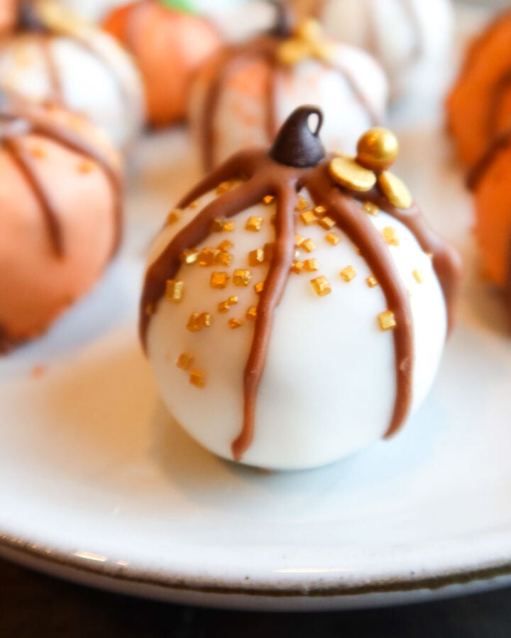 Mini chocolate covered pumpkin bites on a plate.