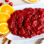 Homemade cranberry sauce on a white serving plate.