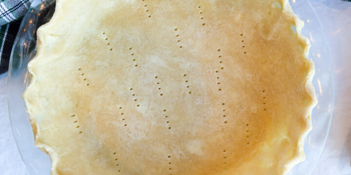 Pie crust in a glass pie dish.