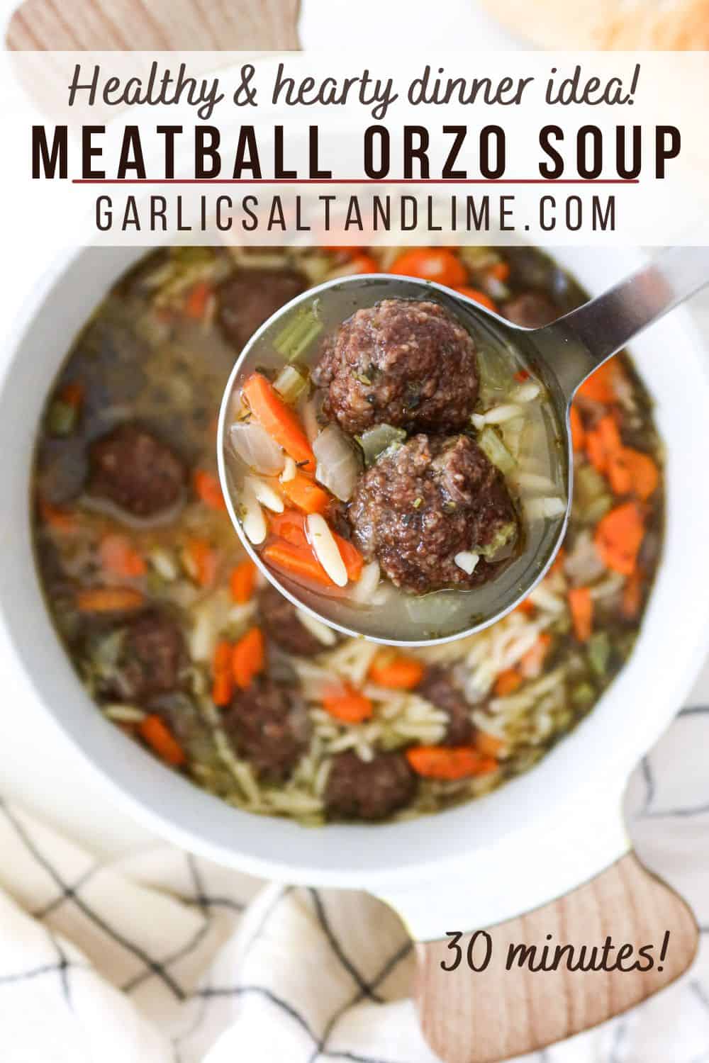 Closeup of a ladle full of meatball orzo soup with text overlay for Pinterest.