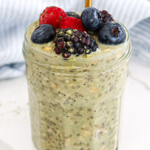 Matcha overnight oats with berries on top.