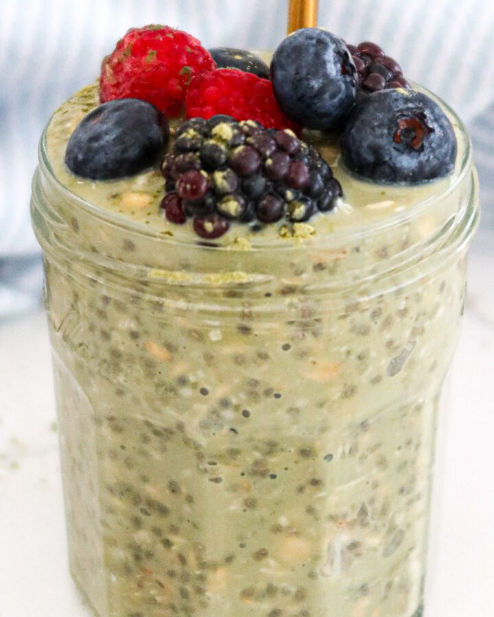 Matcha overnight oats with berries on top.