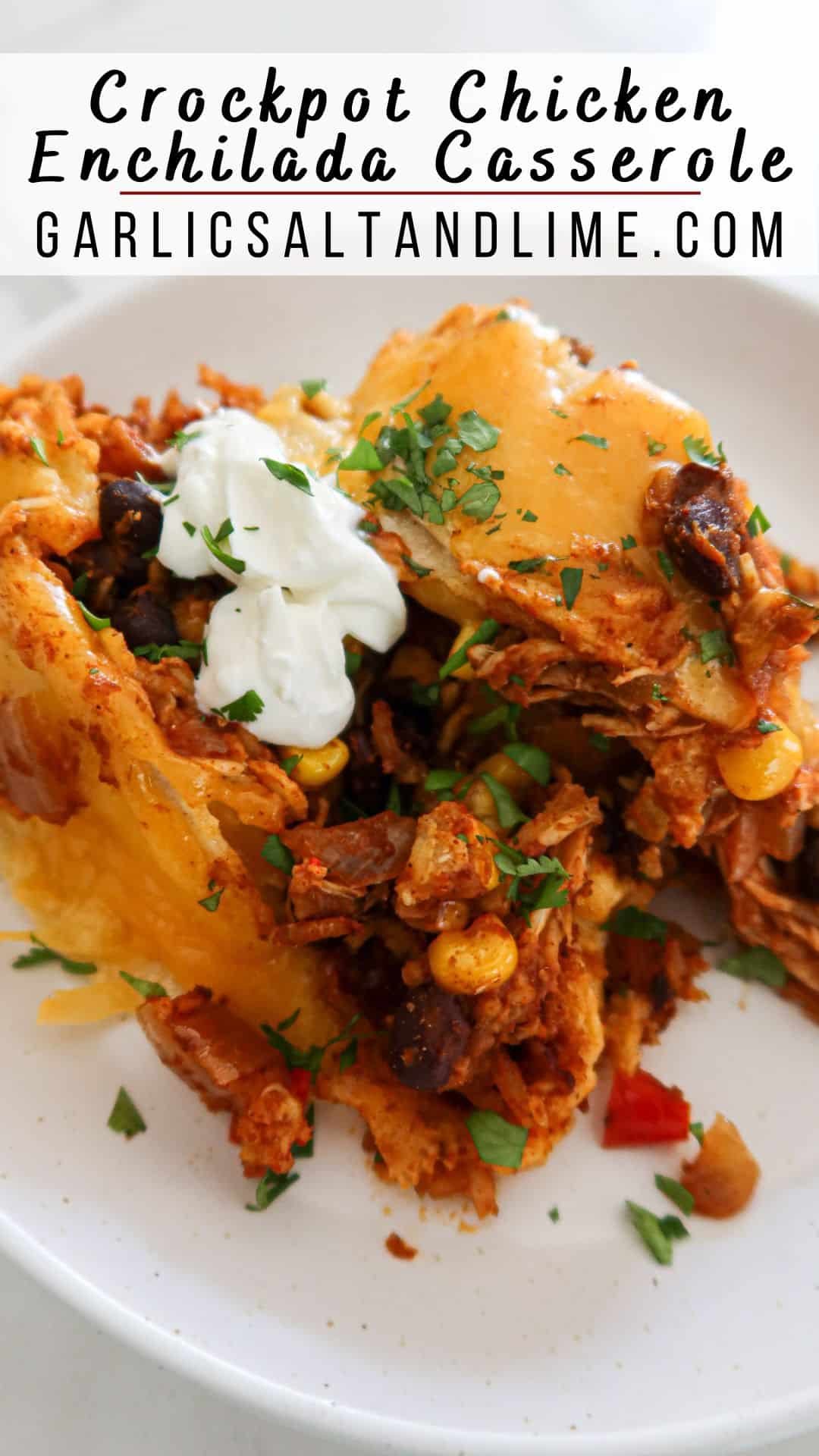 Piece of crockpot enchilada casserole on a plate with text overlay for Pinterest.