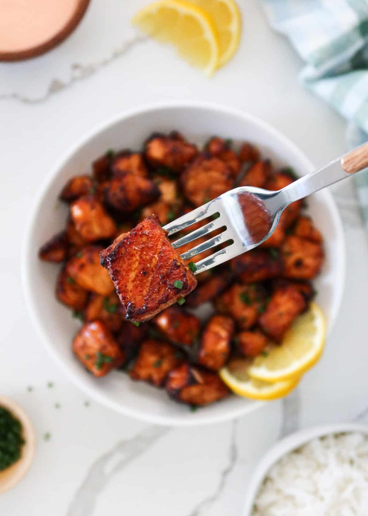 Close up of an air fryer salmon bite on a fork.